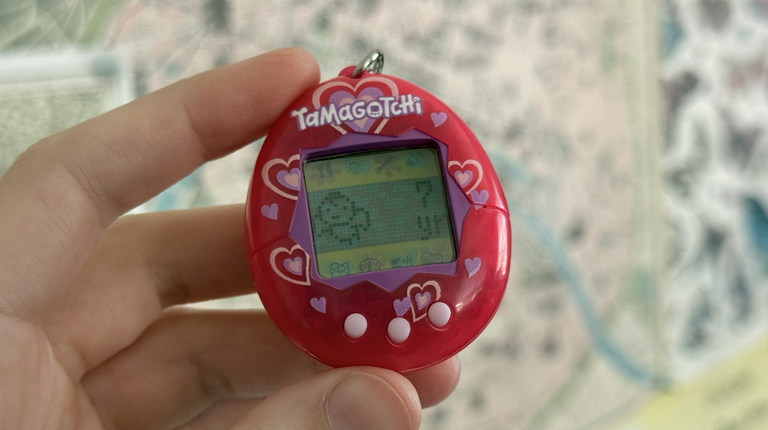 A hot pink Tamagotchi that is dead. It was 7 years old.